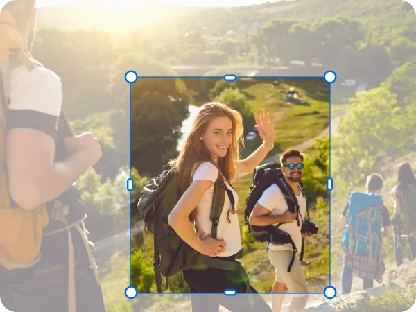 Cropped image focusing on two hikers from a larger group in the mountains.