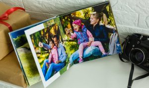 A photobook standing open next to a camera