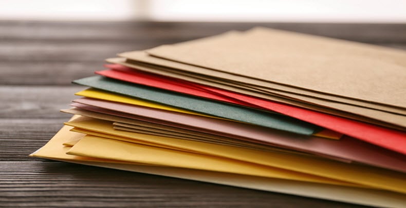 Stack of greetings cards in colored envelopes